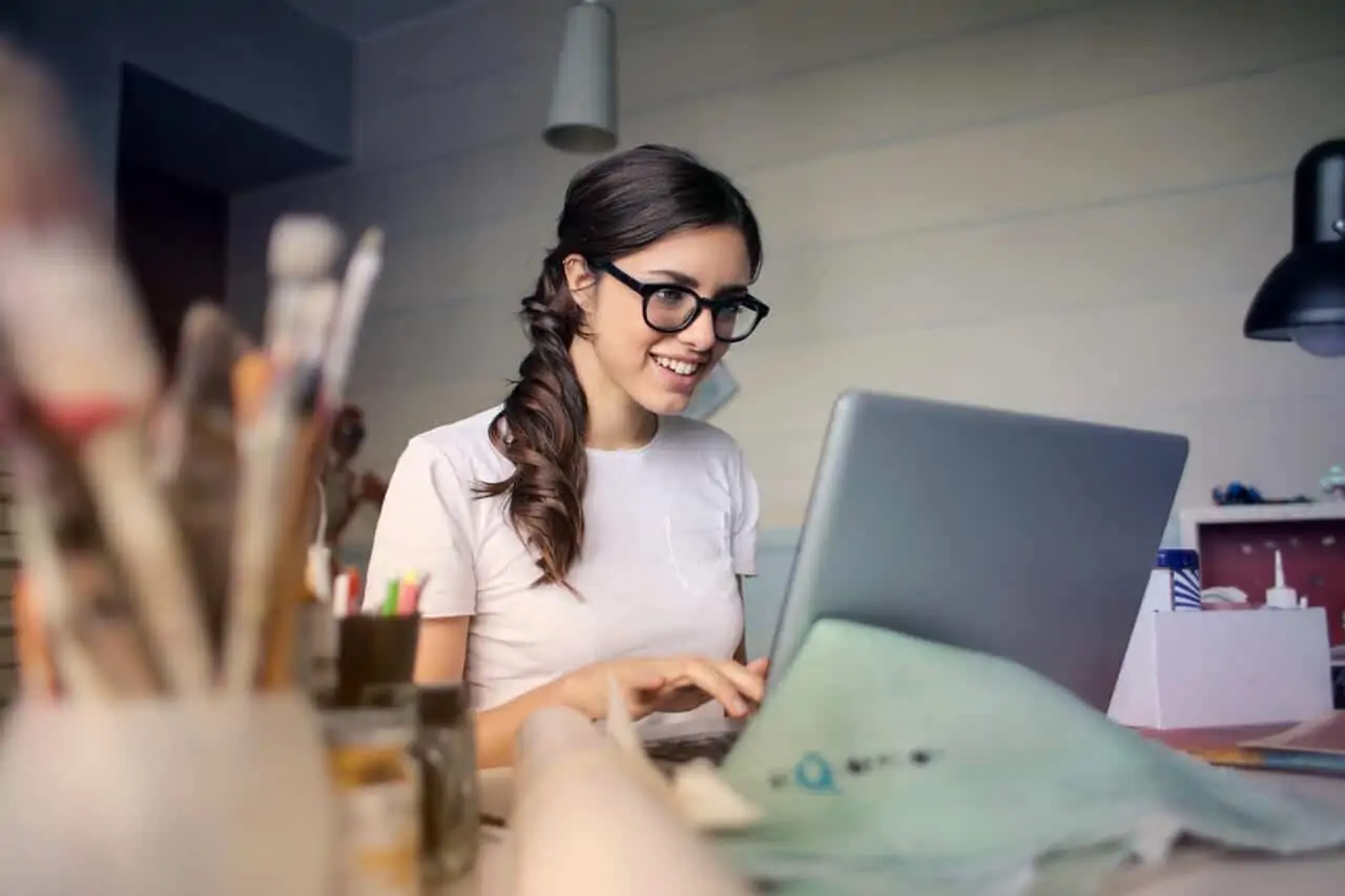 person writing in front of computer